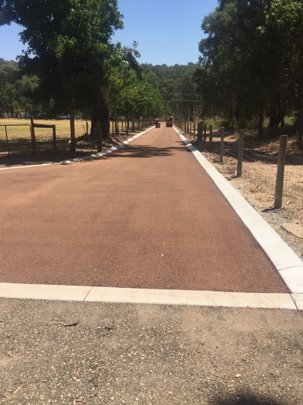 This is a photo of a hot spray & seal bitumen roadway which is in the process of being installed by Bannockburn Road Tech